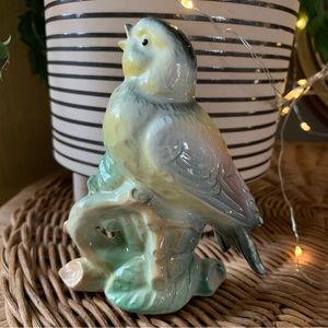 vintage blue and yellow porcelain bird perched on branch